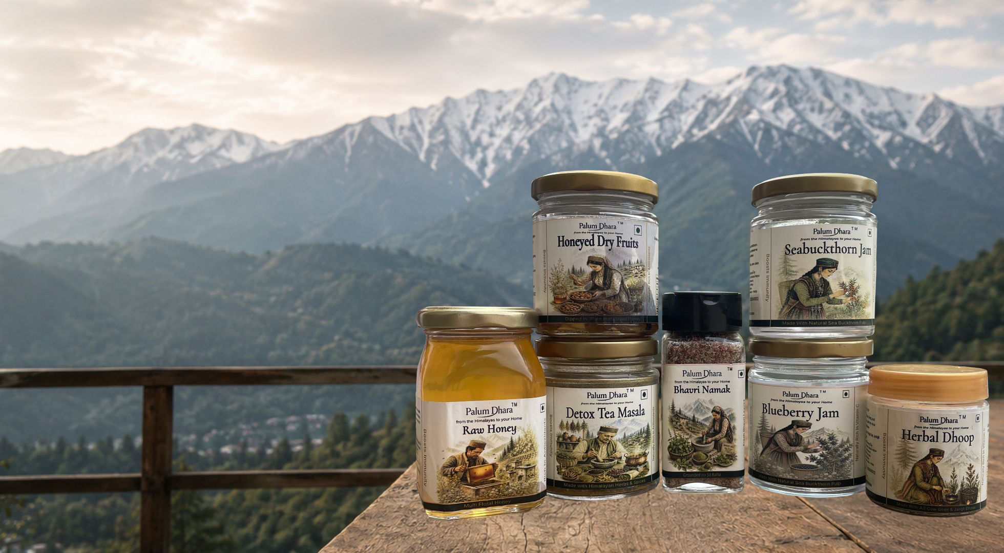 Palum Dhara tea, honey, squash, jam, pickle and oil arranged on a wooden table before the Dhauladhar range